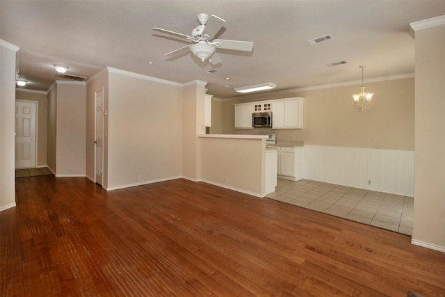 4512 Blue Jay Ln, Sherman, TX 75092 - unfurnished living room featuring hardwood / wood-style flooring, a ceiling fan, crown molding, a chandelier, and wainscoting