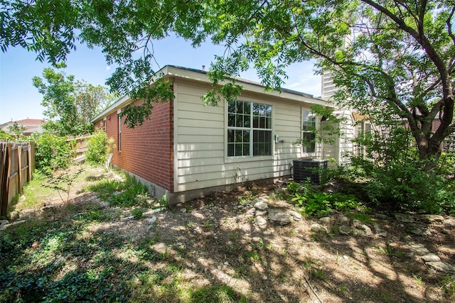 4512 Blue Jay Ln, Sherman, TX 75092 - rear view of house featuring central AC unit, a chimney, and brick siding
