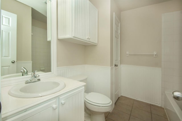 4512 Blue Jay Ln, Sherman, TX 75092 - bathroom with a wainscoted wall, vanity, toilet, tile patterned flooring, and  shower combination