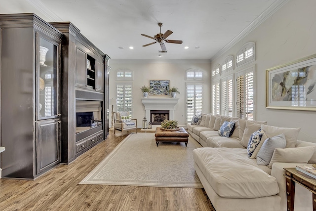 1516 Byron Nelson Pkwy, Southlake, TX 76092 - living area with a fireplace with raised hearth, a ceiling fan, light wood-style floors, crown molding, and recessed lighting