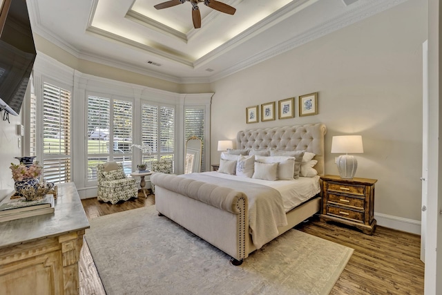 1516 Byron Nelson Pkwy, Southlake, TX 76092 - bedroom with wood finished floors, ornamental molding, a raised ceiling, and a ceiling fan