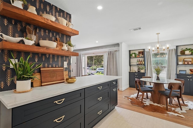 916 Carondolet Ct, River Oaks, TX 76114 - kitchen featuring open shelves, a chandelier, dark cabinetry, recessed lighting, and hanging light fixtures