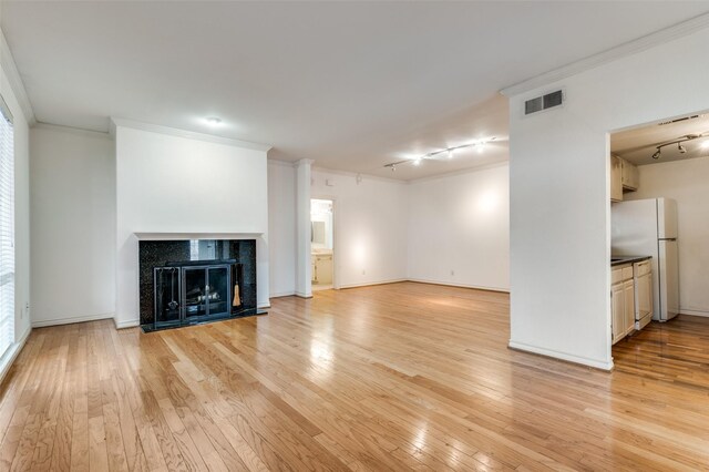 3208 Cole Ave Unit 2205, Dallas, TX 75204 - unfurnished living room with rail lighting, ornamental molding, light wood-type flooring, healthy amount of natural light, and baseboards