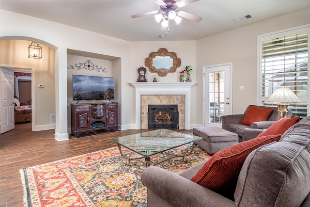 2636 Deer Hollow Dr, Little Elm, TX 75068 - living area featuring wood finished floors, ceiling fan, arched walkways, baseboards, and a fireplace