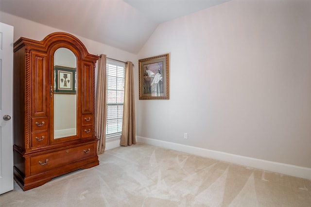 2636 Deer Hollow Dr, Little Elm, TX 75068 - unfurnished bedroom featuring light carpet, vaulted ceiling, and baseboards