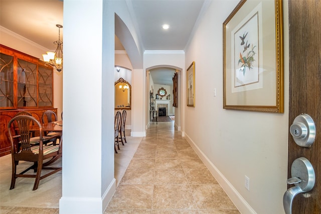2636 Deer Hollow Dr, Little Elm, TX 75068 - hall featuring arched walkways, ornamental molding, a chandelier, and baseboards