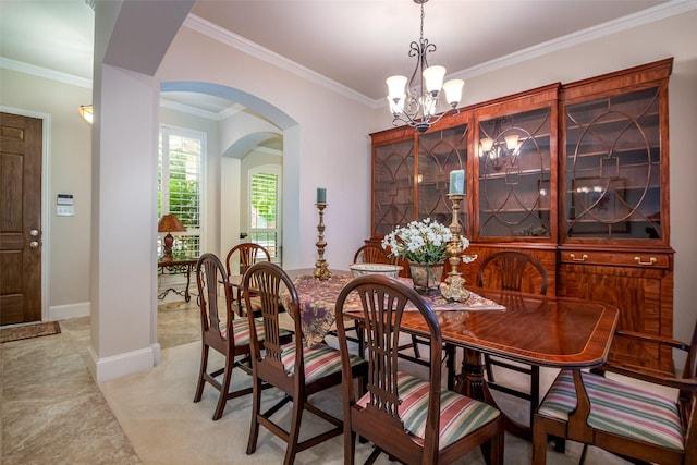 2636 Deer Hollow Dr, Little Elm, TX 75068 - dining area with arched walkways, a chandelier, ornamental molding, light colored carpet, and baseboards