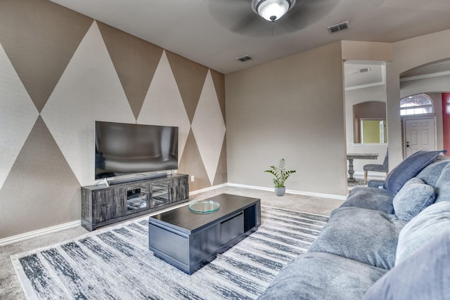 6939 Truth Dr, Dallas, TX 75236 - carpeted living area with arched walkways, baseboards, and a ceiling fan