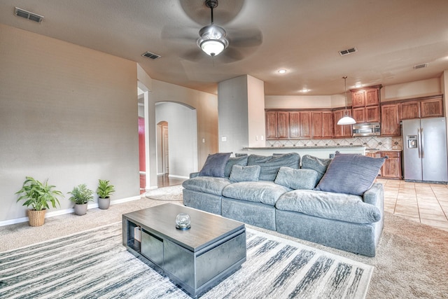 6939 Truth Dr, Dallas, TX 75236 - living room with arched walkways, light carpet, a ceiling fan, and baseboards
