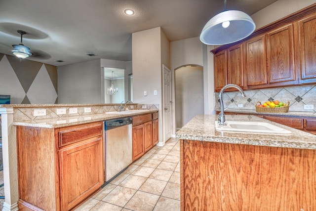 6939 Truth Dr, Dallas, TX 75236 - kitchen with stainless steel dishwasher, arched walkways, a sink, and a peninsula