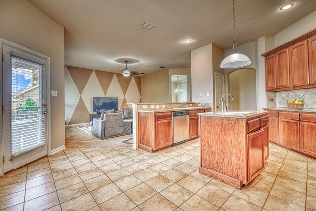 6939 Truth Dr, Dallas, TX 75236 - kitchen featuring a sink, stainless steel dishwasher, a center island with sink, open floor plan, and pendant lighting