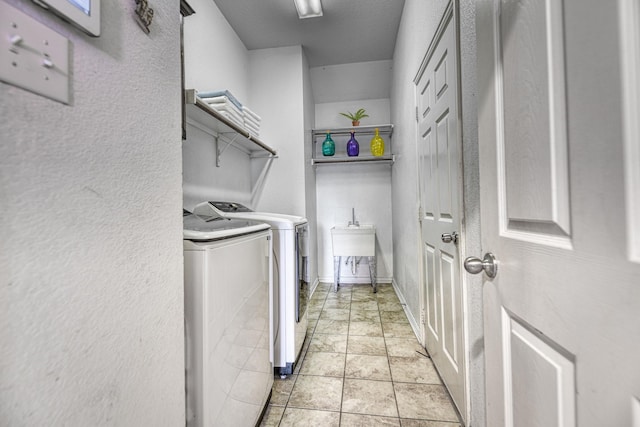 6939 Truth Dr, Dallas, TX 75236 - laundry room featuring washing machine and dryer and a textured wall