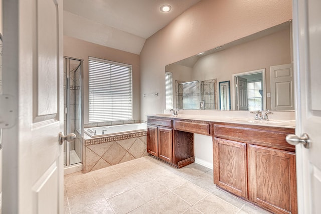 6939 Truth Dr, Dallas, TX 75236 - full bath featuring a stall shower, double vanity, a garden tub, healthy amount of natural light, and vaulted ceiling