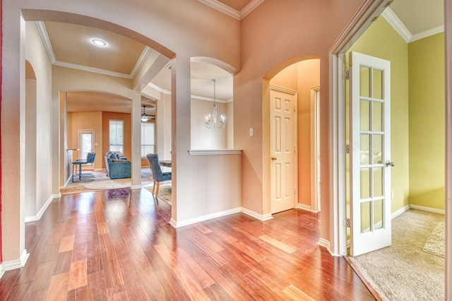 6939 Truth Dr, Dallas, TX 75236 - foyer entrance with arched walkways, wood finished floors, ornamental molding, and baseboards