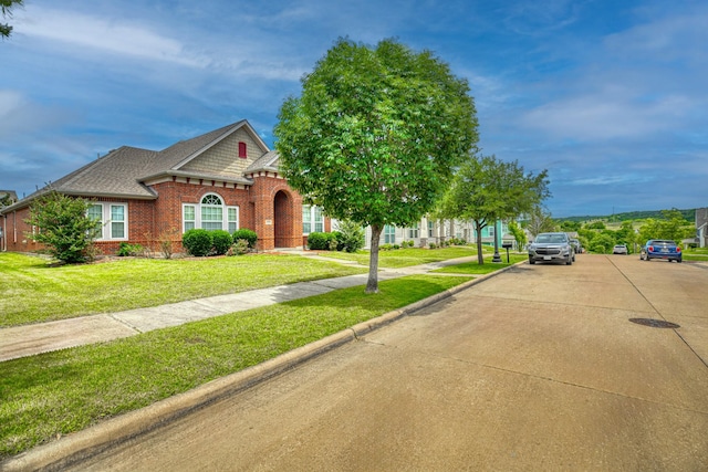 6939 Truth Dr, Dallas, TX 75236 - view of front of house with brick siding, a front yard, and a shingled roof