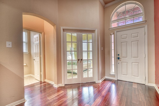 6939 Truth Dr, Dallas, TX 75236 - entrance foyer featuring arched walkways, french doors, wood finished floors, baseboards, and a textured wall