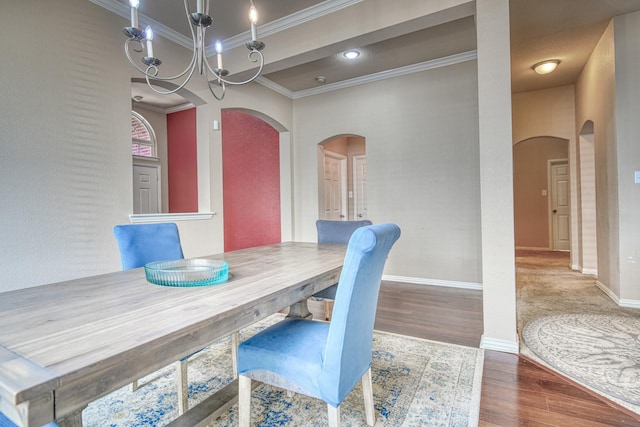 6939 Truth Dr, Dallas, TX 75236 - dining room with arched walkways, ornamental molding, wood finished floors, a chandelier, and baseboards