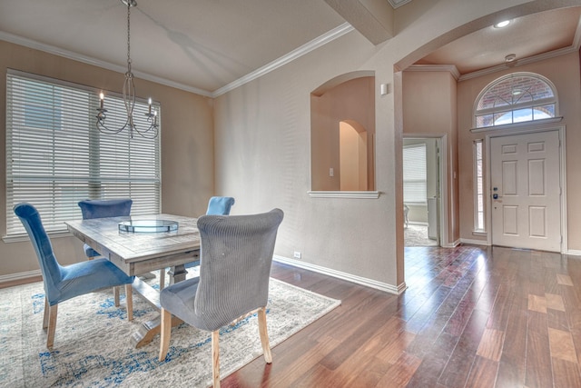 6939 Truth Dr, Dallas, TX 75236 - dining room featuring a chandelier, arched walkways, baseboards, wood finished floors, and ornamental molding