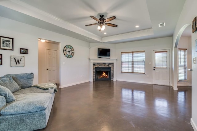 1759 County Road 2712, Caddo Mills, TX 75135 - living room with a raised ceiling, a ceiling fan, baseboards, a stone fireplace, and arched walkways