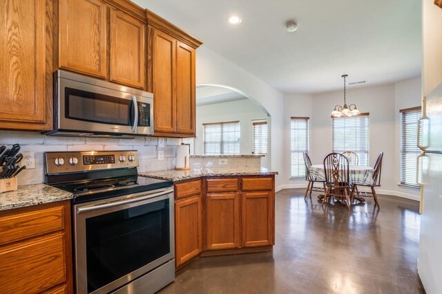 1759 County Road 2712, Caddo Mills, TX 75135 - kitchen featuring appliances with stainless steel finishes, brown cabinets, concrete flooring, baseboards, and recessed lighting