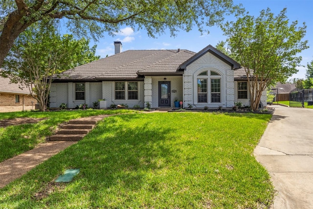 517 Sunset Dr, Hurst, TX 76054 - view of front of property featuring a chimney, brick siding, a front yard, and a tile roof