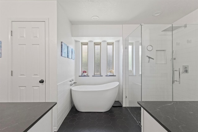 517 Sunset Dr, Hurst, TX 76054 - full bathroom with a stall shower, a freestanding bath, tile patterned flooring, tile walls, and vanity