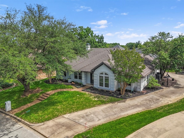 517 Sunset Dr, Hurst, TX 76054 - view of front facade with a front lawn, a tile roof, an attached garage, concrete driveway, and stone siding