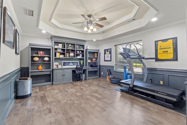 517 Sunset Dr, Hurst, TX 76054 - office featuring a raised ceiling, crown molding, ceiling fan, built in desk, and wainscoting