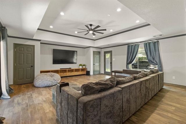 517 Sunset Dr, Hurst, TX 76054 - living room featuring crown molding, wood finished floors, a raised ceiling, a ceiling fan, and recessed lighting