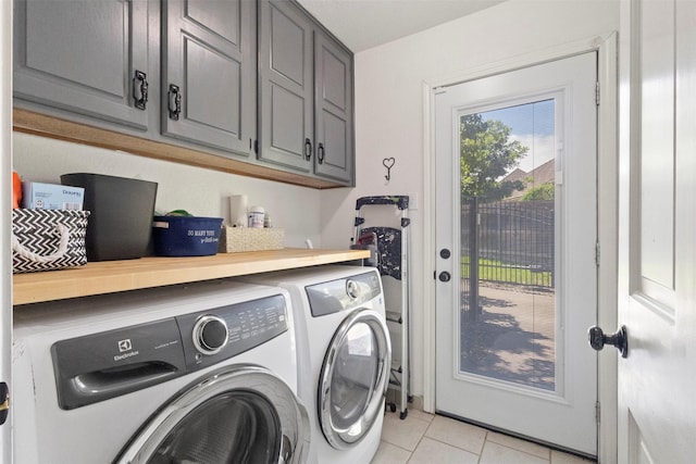 517 Sunset Dr, Hurst, TX 76054 - laundry area with cabinet space, independent washer and dryer, and light tile patterned floors