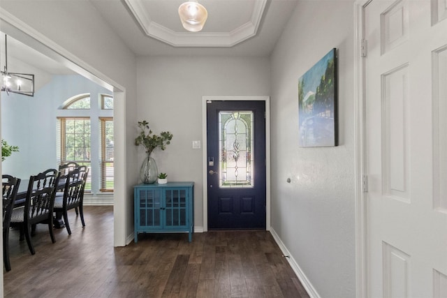 517 Sunset Dr, Hurst, TX 76054 - entrance foyer with dark wood-type flooring, a chandelier, crown molding, a raised ceiling, and baseboards
