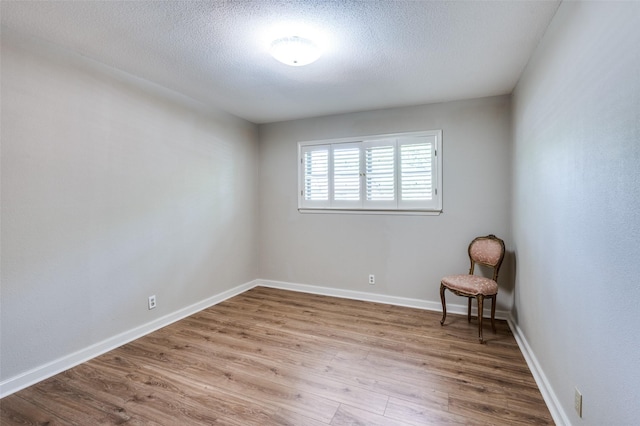 1913 Windlea Dr, Euless, TX 76040 - empty room featuring wood finished floors, a textured ceiling, and baseboards