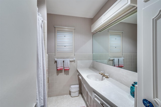 1913 Windlea Dr, Euless, TX 76040 - bathroom with tile walls, vanity, wainscoting, and tile patterned flooring