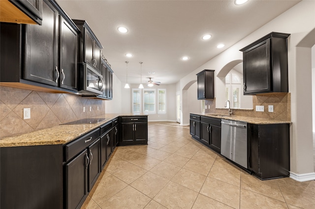 5505 Wisdom Ct, Waco, TX 76708 - kitchen featuring appliances with stainless steel finishes, a sink, baseboards, light tile patterned floors, and light stone counters