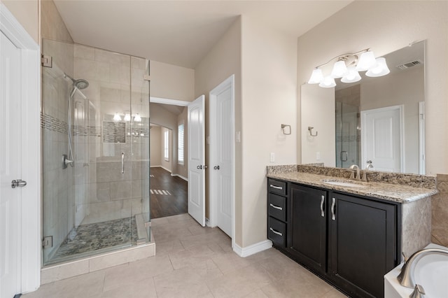 5505 Wisdom Ct, Waco, TX 76708 - full bath featuring a chandelier, a stall shower, vanity, baseboards, and a bath