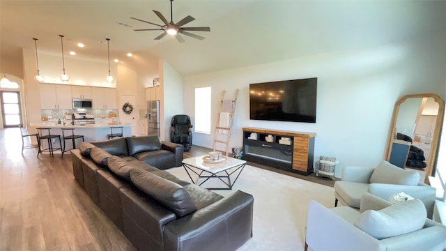 1605 Anacua Ln, Wylie, TX 75098 - living area with vaulted ceiling, light wood-type flooring, and a ceiling fan
