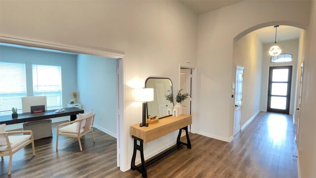 1605 Anacua Ln, Wylie, TX 75098 - foyer entrance with arched walkways, wood finished floors, baseboards, and a towering ceiling