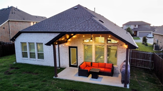 1605 Anacua Ln, Wylie, TX 75098 - back of property with brick siding, an outdoor hangout area, a patio area, and a shingled roof