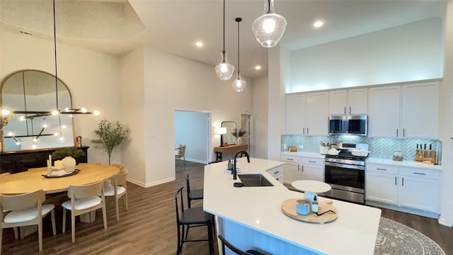 1605 Anacua Ln, Wylie, TX 75098 - kitchen with stainless steel appliances, a sink, tasteful backsplash, a high ceiling, and dark wood finished floors