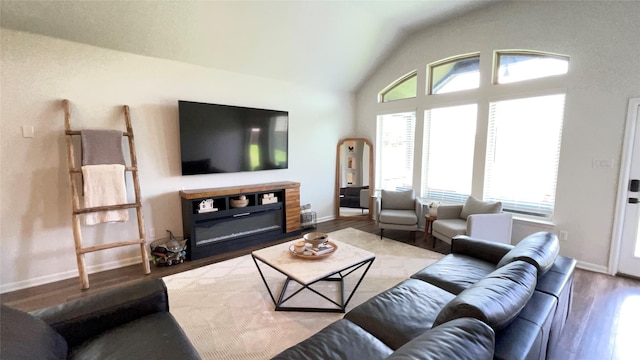 1605 Anacua Ln, Wylie, TX 75098 - living area with wood finished floors, vaulted ceiling, and baseboards