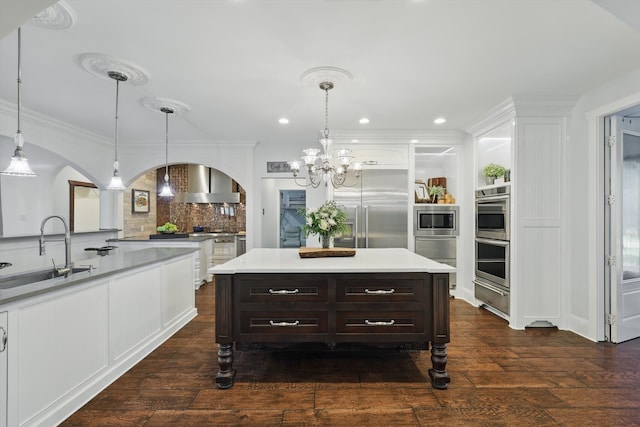 1208 Chandler Cir, Prosper, TX 75078 - kitchen featuring built in appliances, arched walkways, a chandelier, light countertops, and recessed lighting
