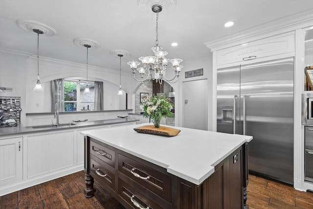 1208 Chandler Cir, Prosper, TX 75078 - kitchen with built in fridge, dark wood finished floors, light countertops, white cabinets, and recessed lighting