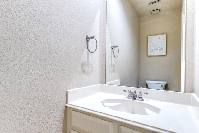 1104 Bayshore St, Allen, TX 75002 - bathroom featuring vanity, a textured wall, and toilet