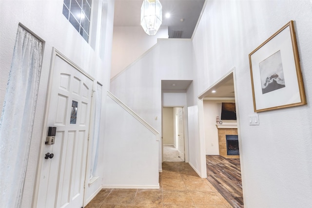 1104 Bayshore St, Allen, TX 75002 - entryway with a towering ceiling, a tiled fireplace, and baseboards