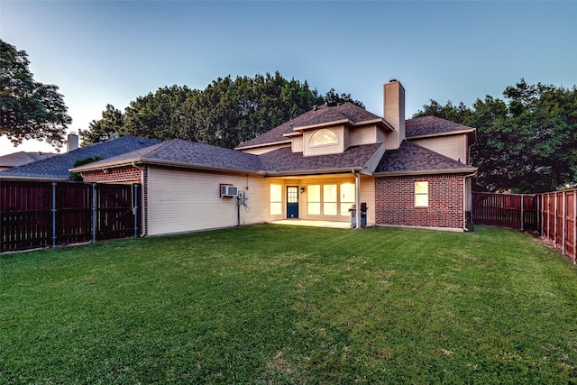 1104 Bayshore St, Allen, TX 75002 - back of property at dusk featuring a chimney, brick siding, and a shingled roof