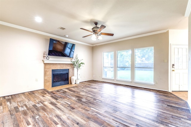 1104 Bayshore St, Allen, TX 75002 - unfurnished living room featuring wood finished floors, a tiled fireplace, ceiling fan, ornamental molding, and recessed lighting