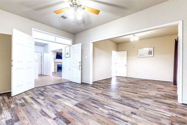 1104 Bayshore St, Allen, TX 75002 - empty room featuring ceiling fan, wood finished floors, a fireplace, and baseboards