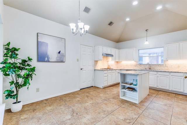 1104 Bayshore St, Allen, TX 75002 - kitchen with decorative backsplash, white cabinetry, vaulted ceiling, open shelves, and hanging light fixtures