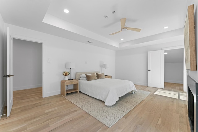 4516 Shenandoah Ave, University Park, TX 75205 - bedroom with a tray ceiling, recessed lighting, light wood finished floors, baseboards, and a ceiling fan