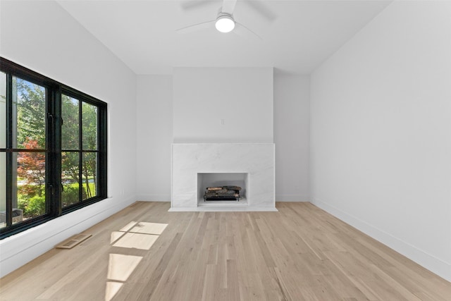 4516 Shenandoah Ave, University Park, TX 75205 - unfurnished living room featuring light wood-type flooring, a fireplace, ceiling fan, and baseboards